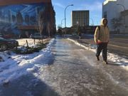 In this January 2017 file photo, pedestrians brave slick sidewalks in downtown Syracuse after freezing rain fell and coated much of Central New York with a treacherous glaze of ice.